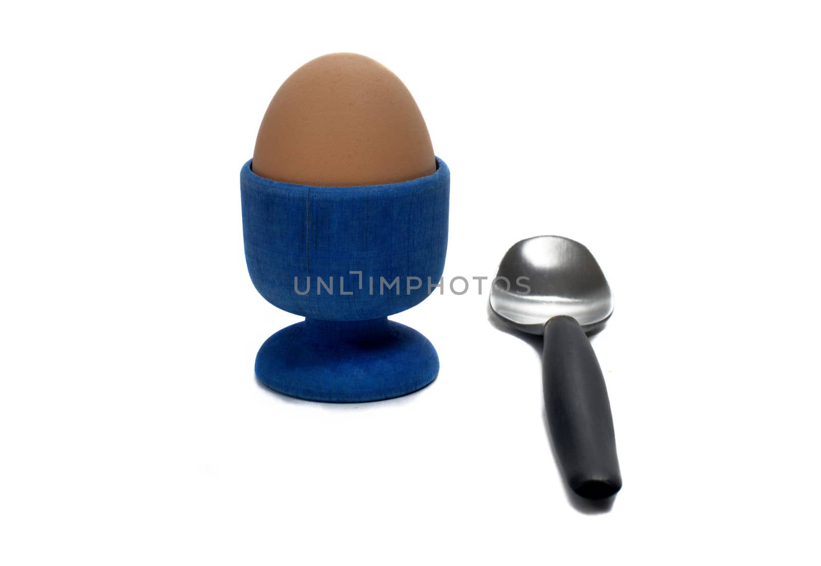 boiled egg in an egg cup with a small spoon