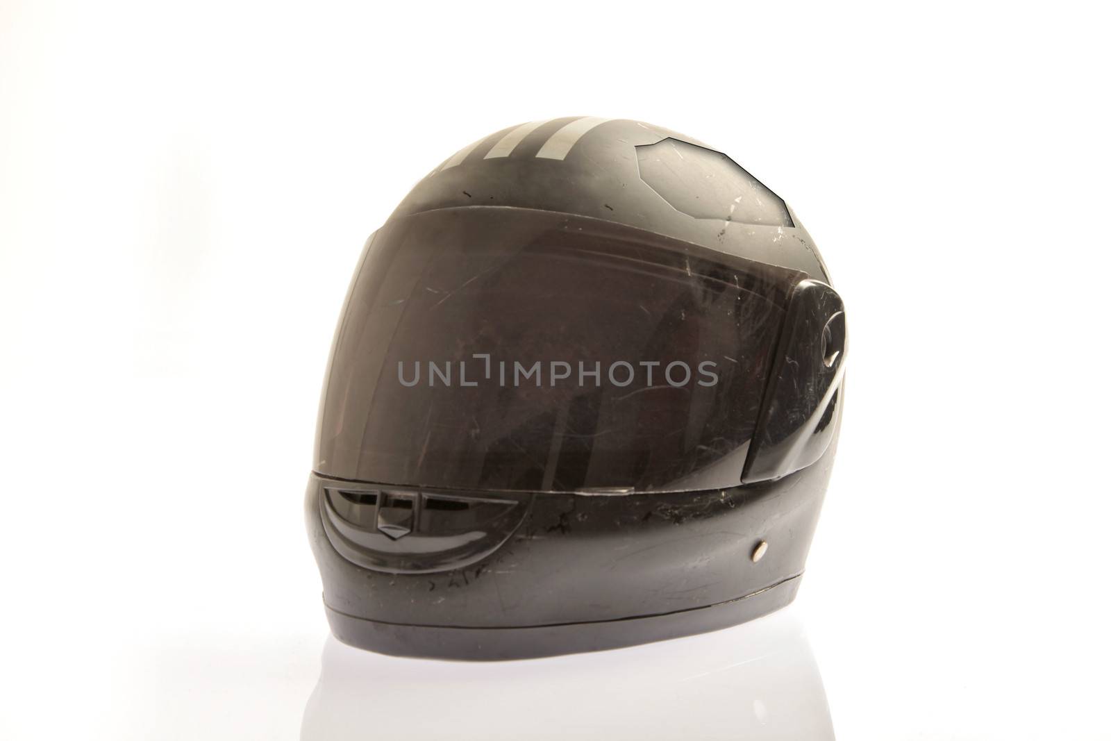 Damaged black coloured motor cycle helmet 
