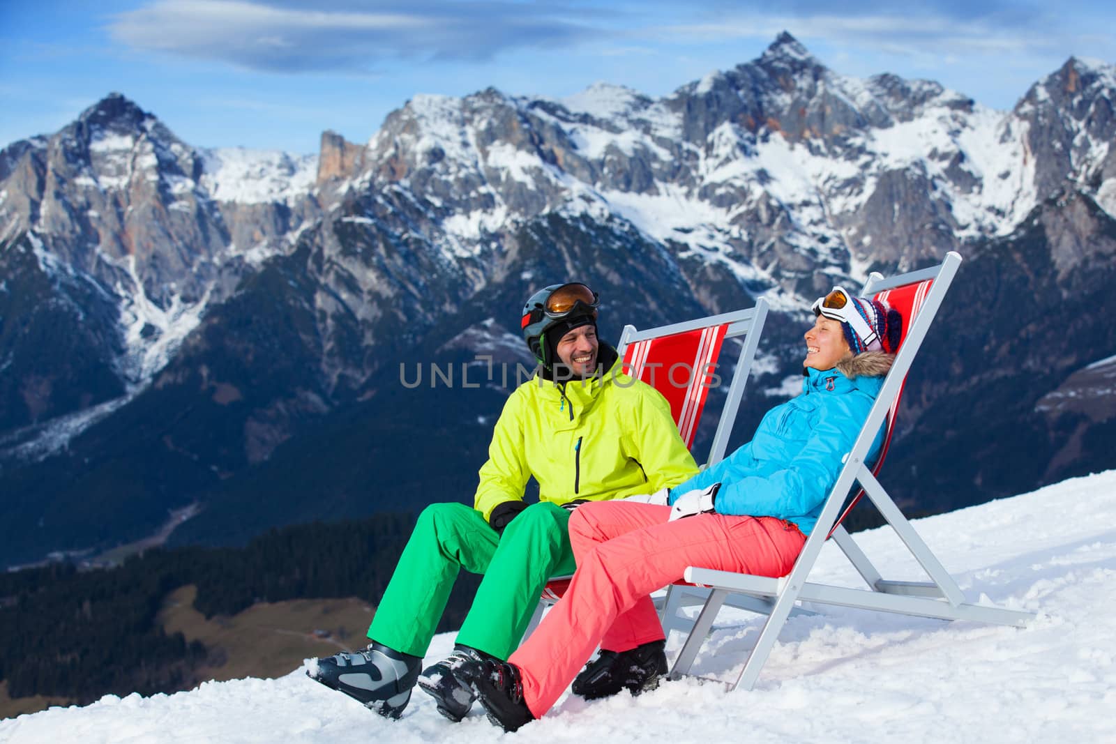 Ski, snow, sun and winter holidays - resting skier in ski resort