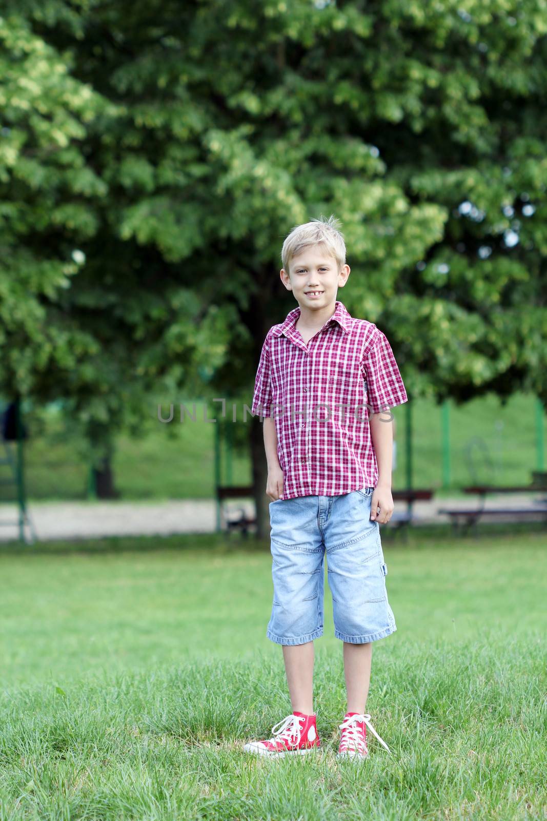 happy boy posing in park by goce