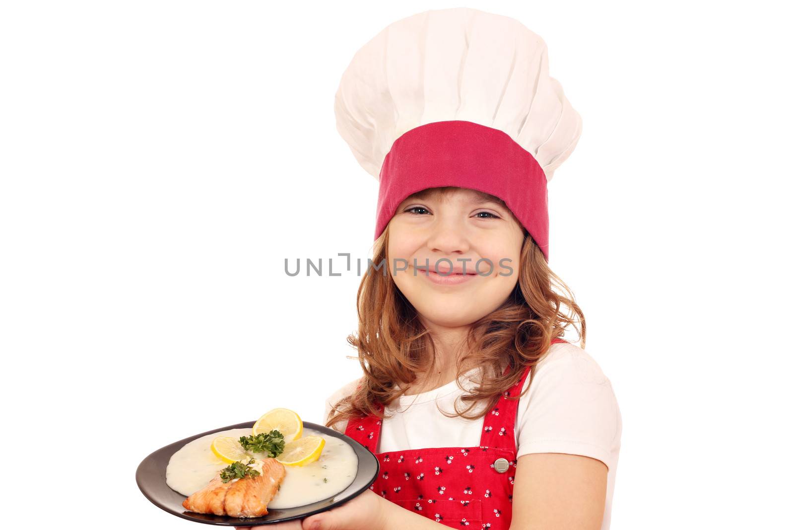 happy little girl cook hold dish with salmon seafood