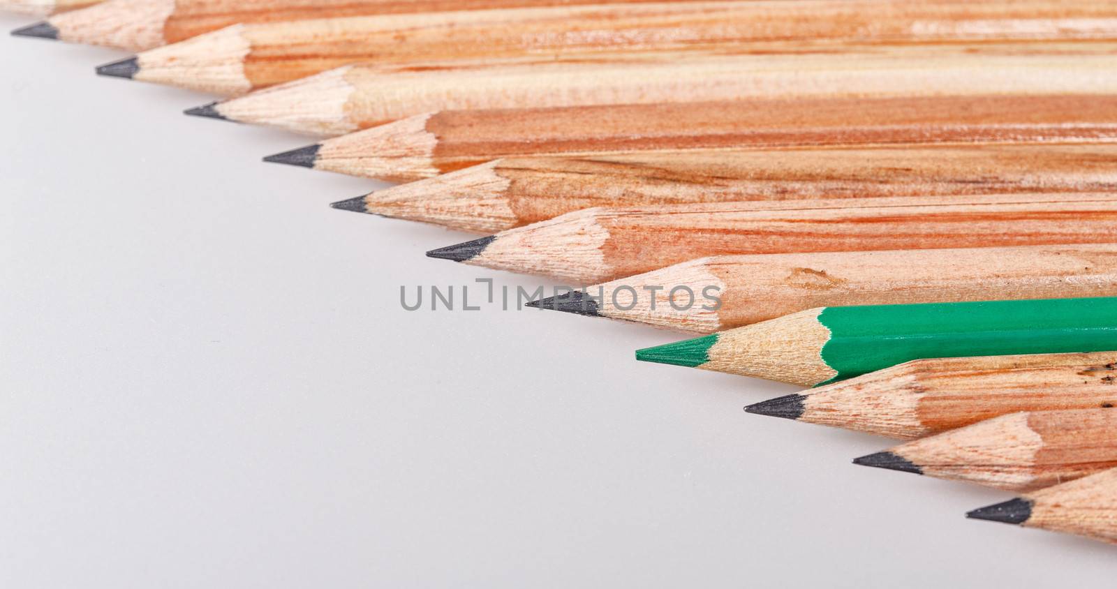 Color pencil stands out against a series of graphite pencils