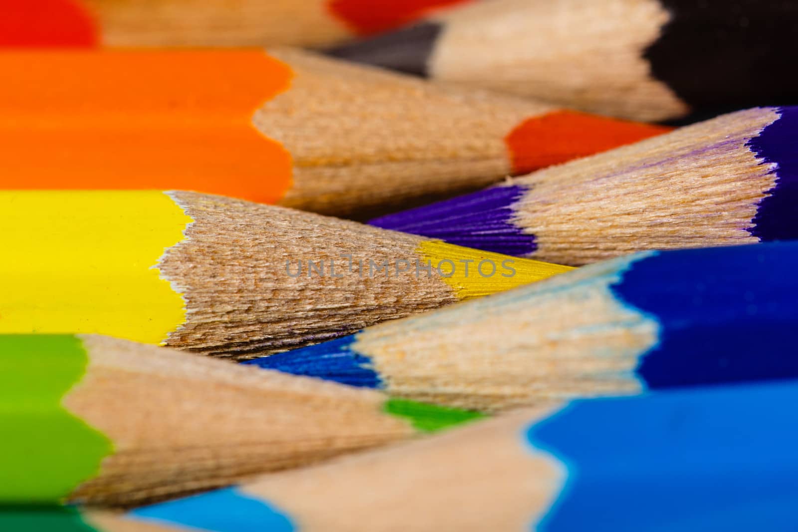 Brightly colored wooden pencils closeup shot background