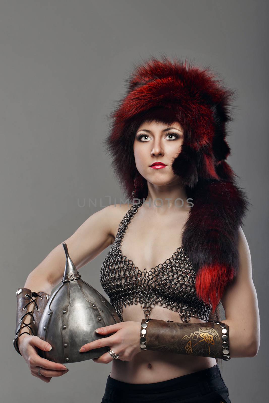 Attractive young girl with historical armor shot in studio