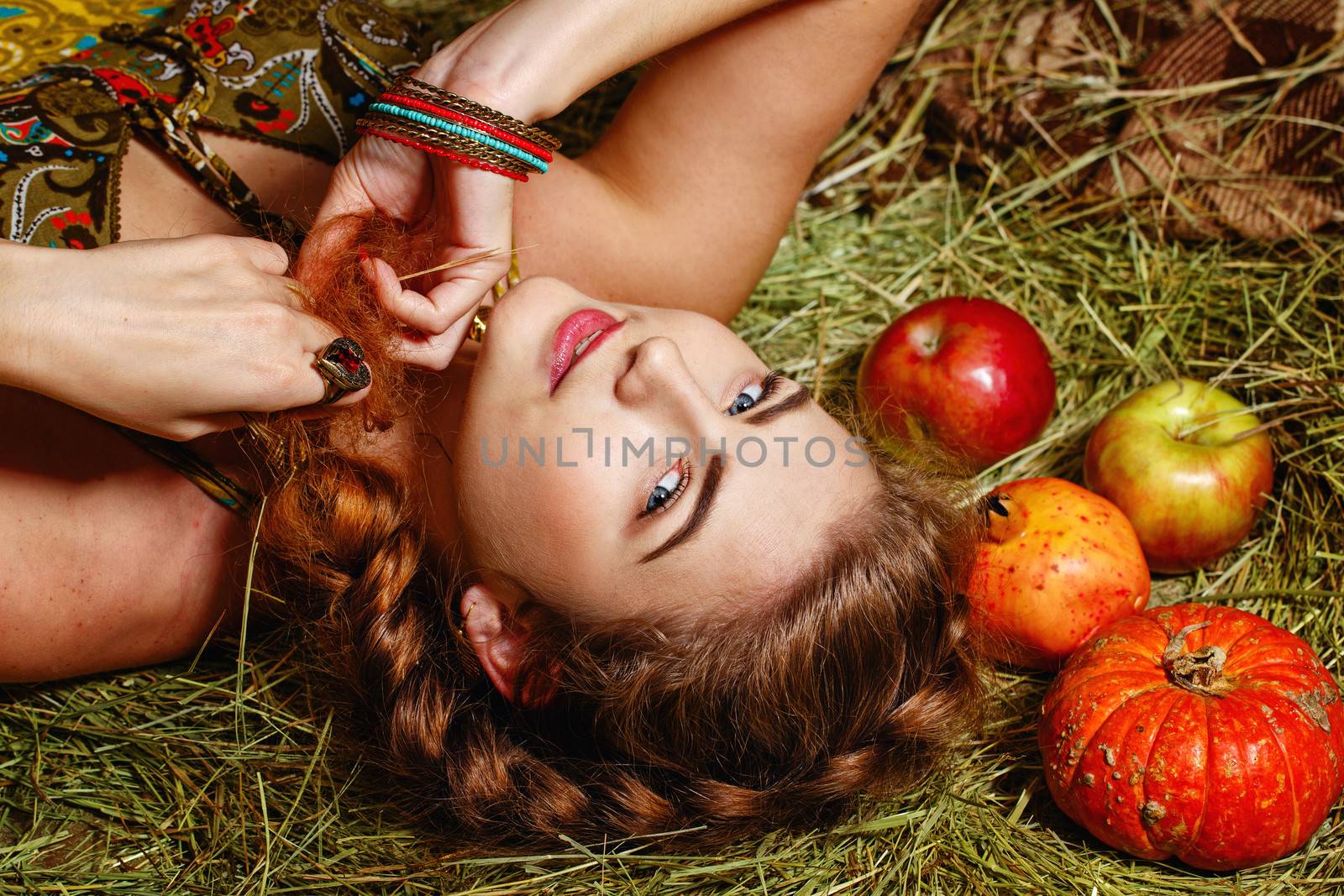 Attractive young rural girl in the hayloft after harvest festival