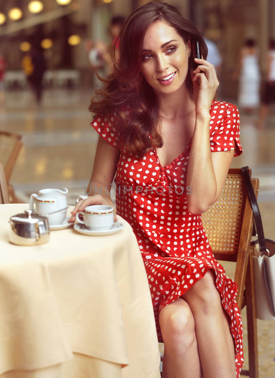 beautiful woman sitting in a Cafe with mobile by toocan