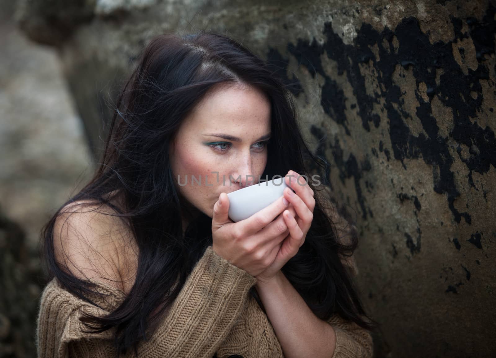 woman drinking tea outdoors by palinchak