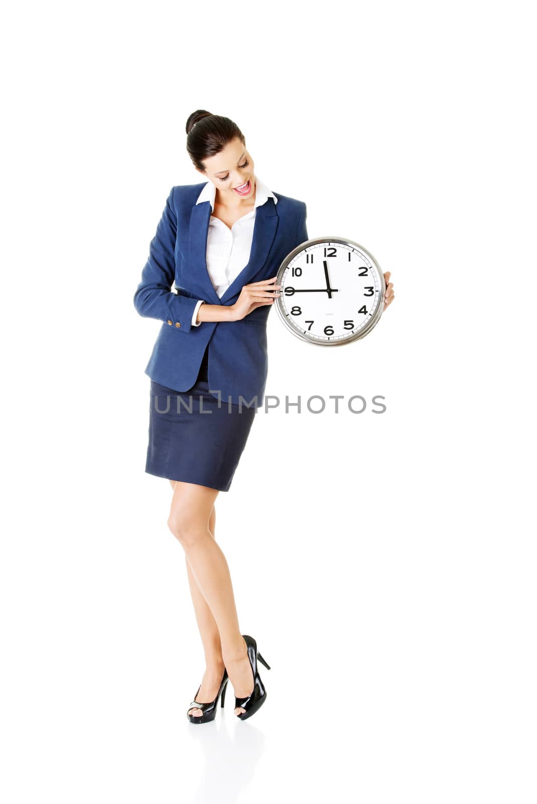 Young business woman holding clock. by BDS