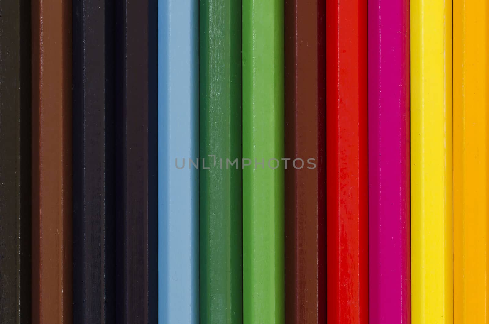 close up of a stack of pencil crayons in many colors creating background