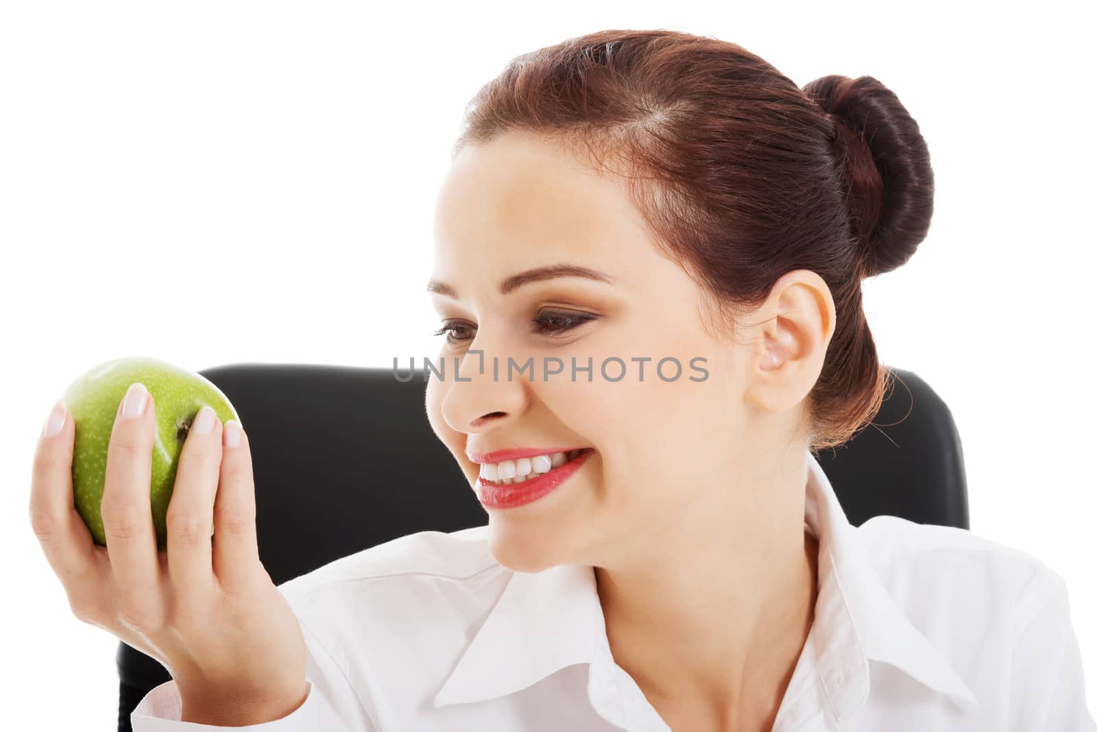 Young beautiful business woman holding an apple. Isolated on white.