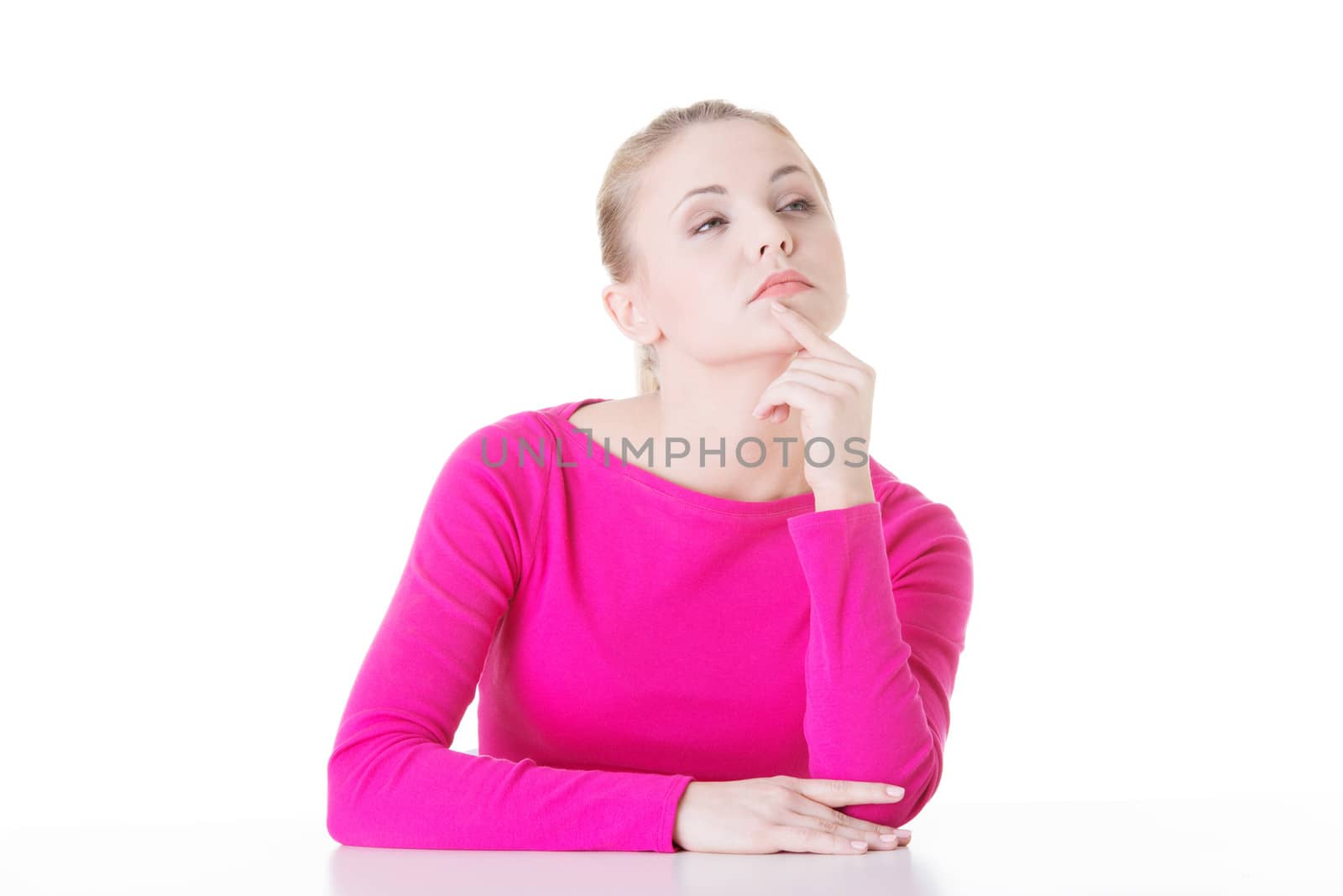 Young happy woman dreaming. Isolated on white.