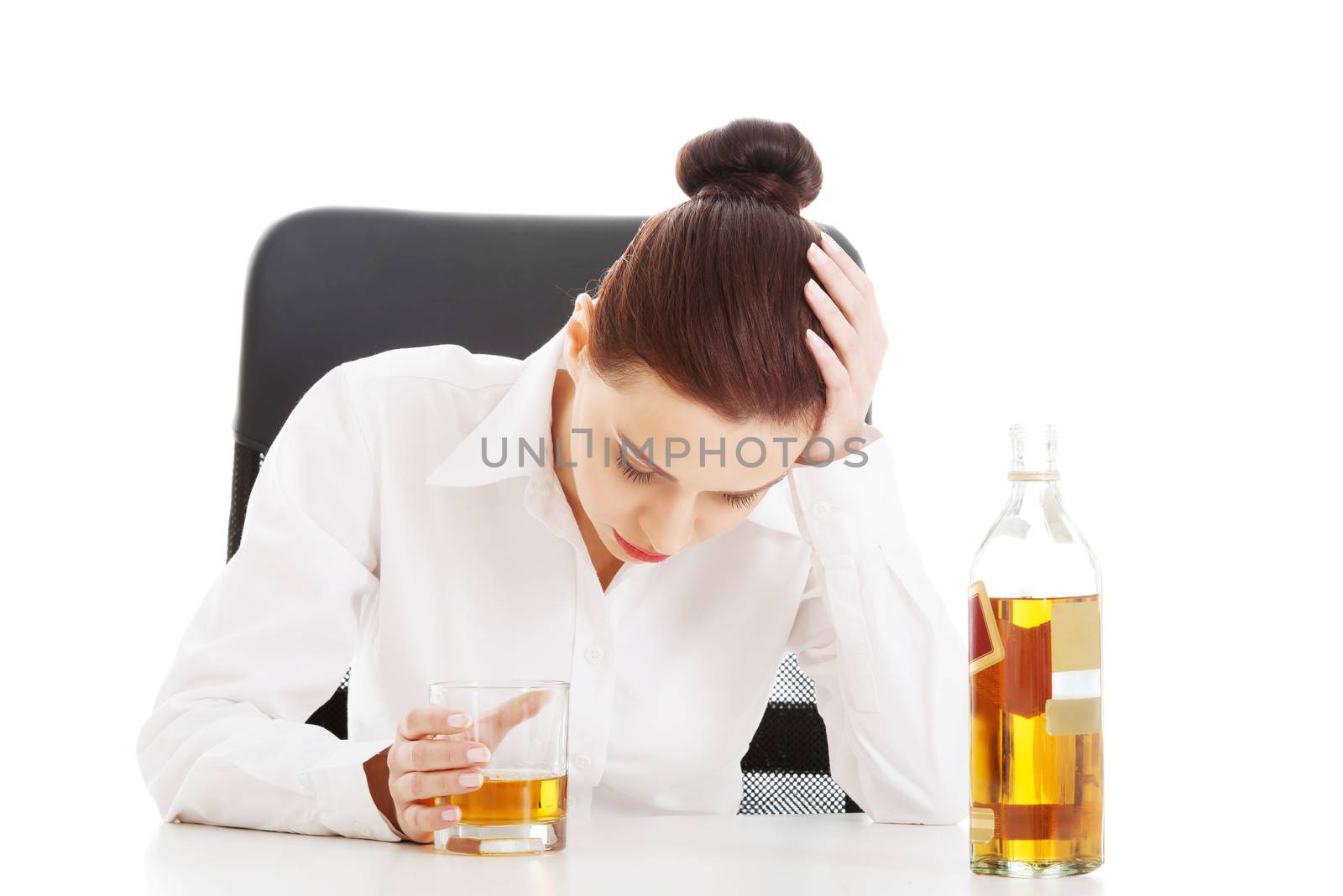 Young beautiful business woman with glass of whisky or rum. Isolated on white.