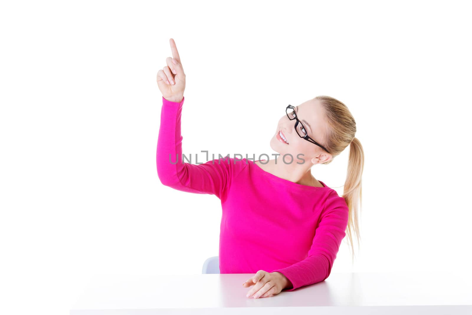 Young casual woman pointing aside. Isolated on white.