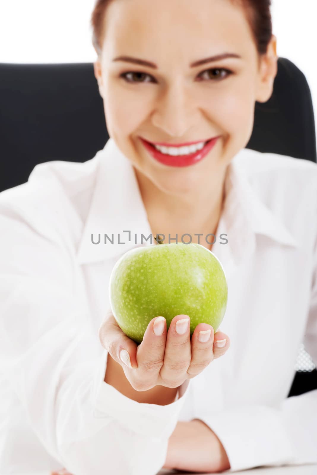 Young beautiful business woman holding an apple. by BDS