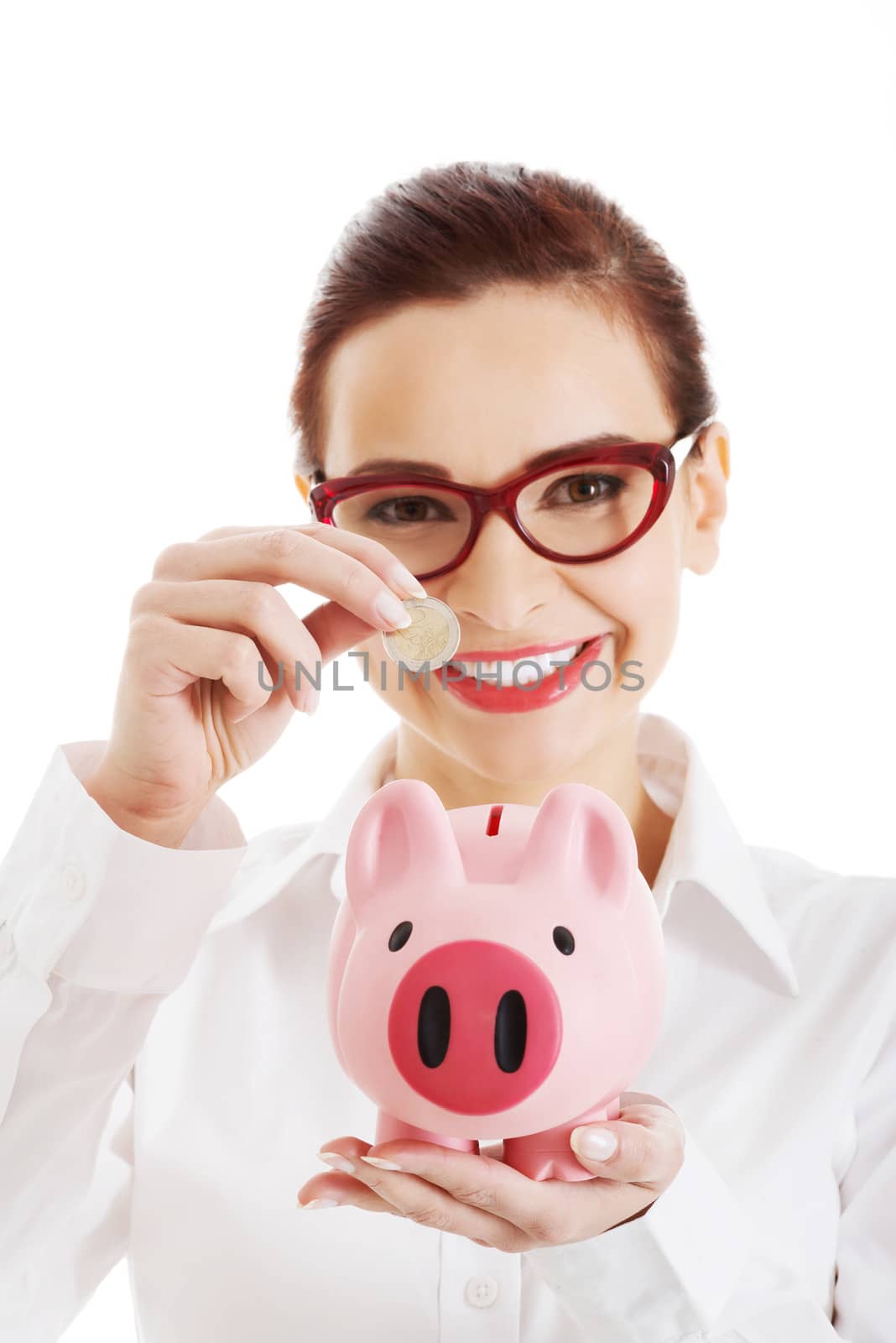 Beautiful business woman with coin and piggy- bank. Isolated on white.