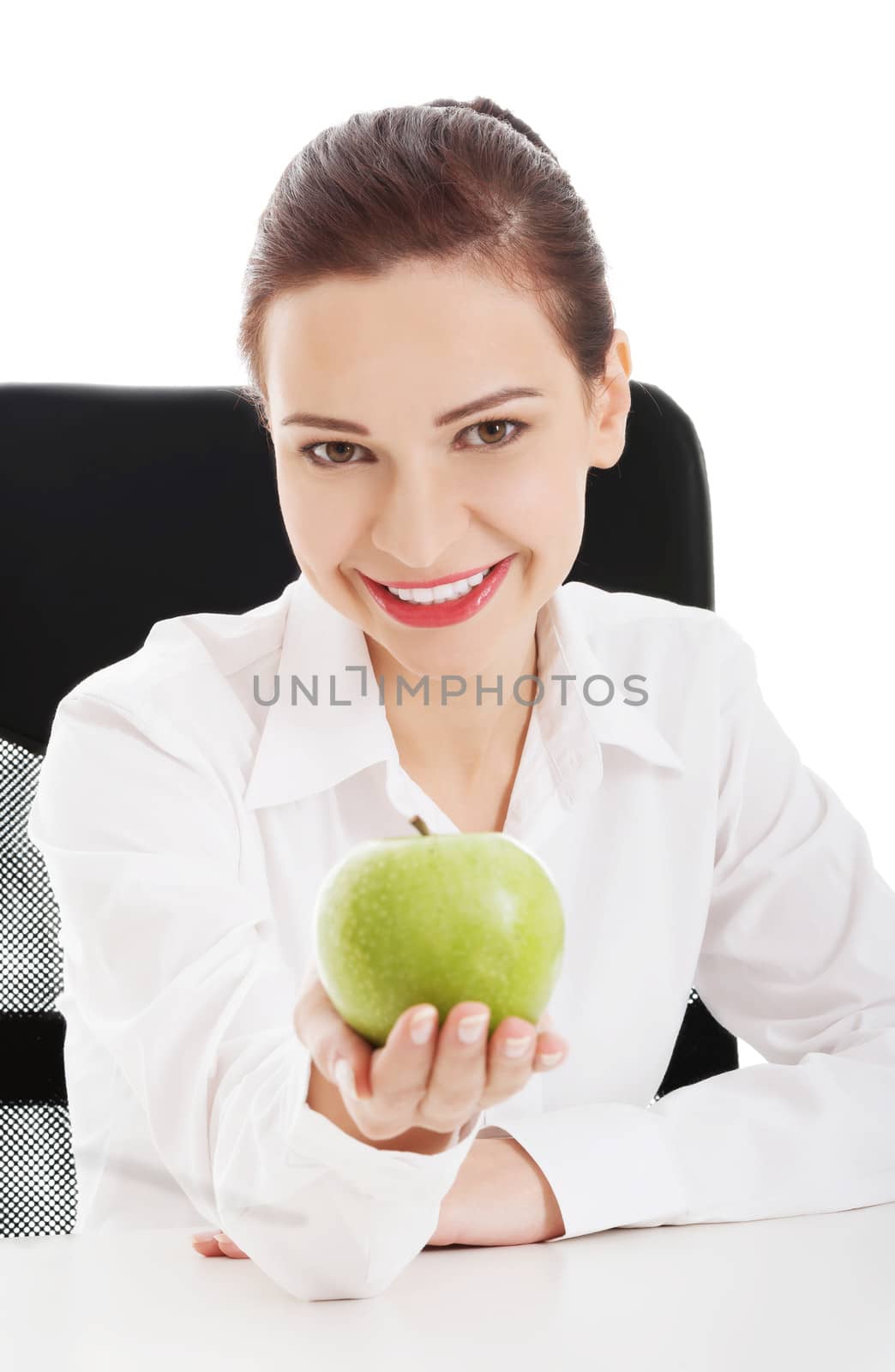 Young beautiful business woman holding an apple. Isolated on white.