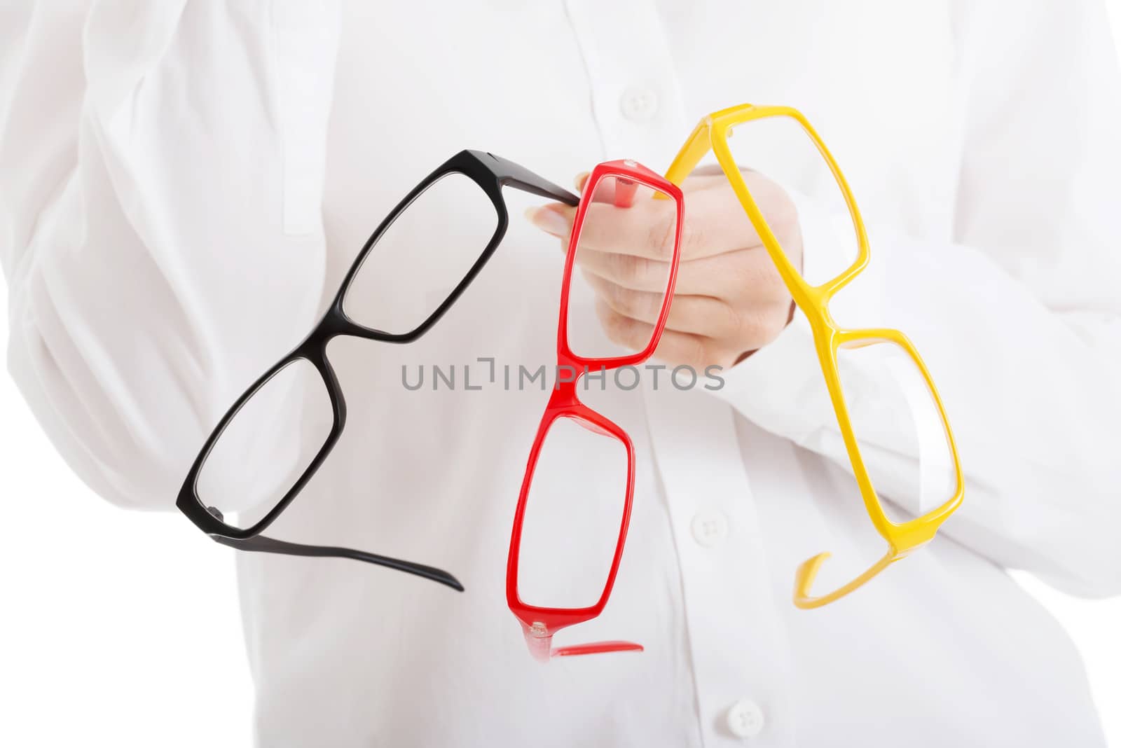 Beautiful woman in eyeglasses holding three different pair of eyeglasses. Isolated on white.