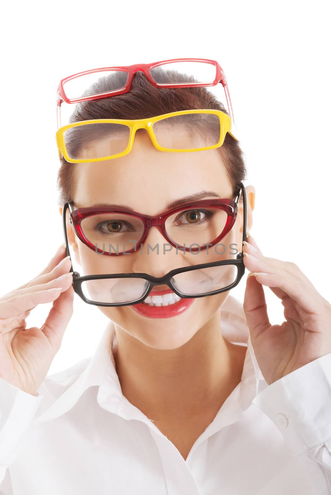 Beautiful woman wearing four different pairs of eyeglasses. Isolated on white.