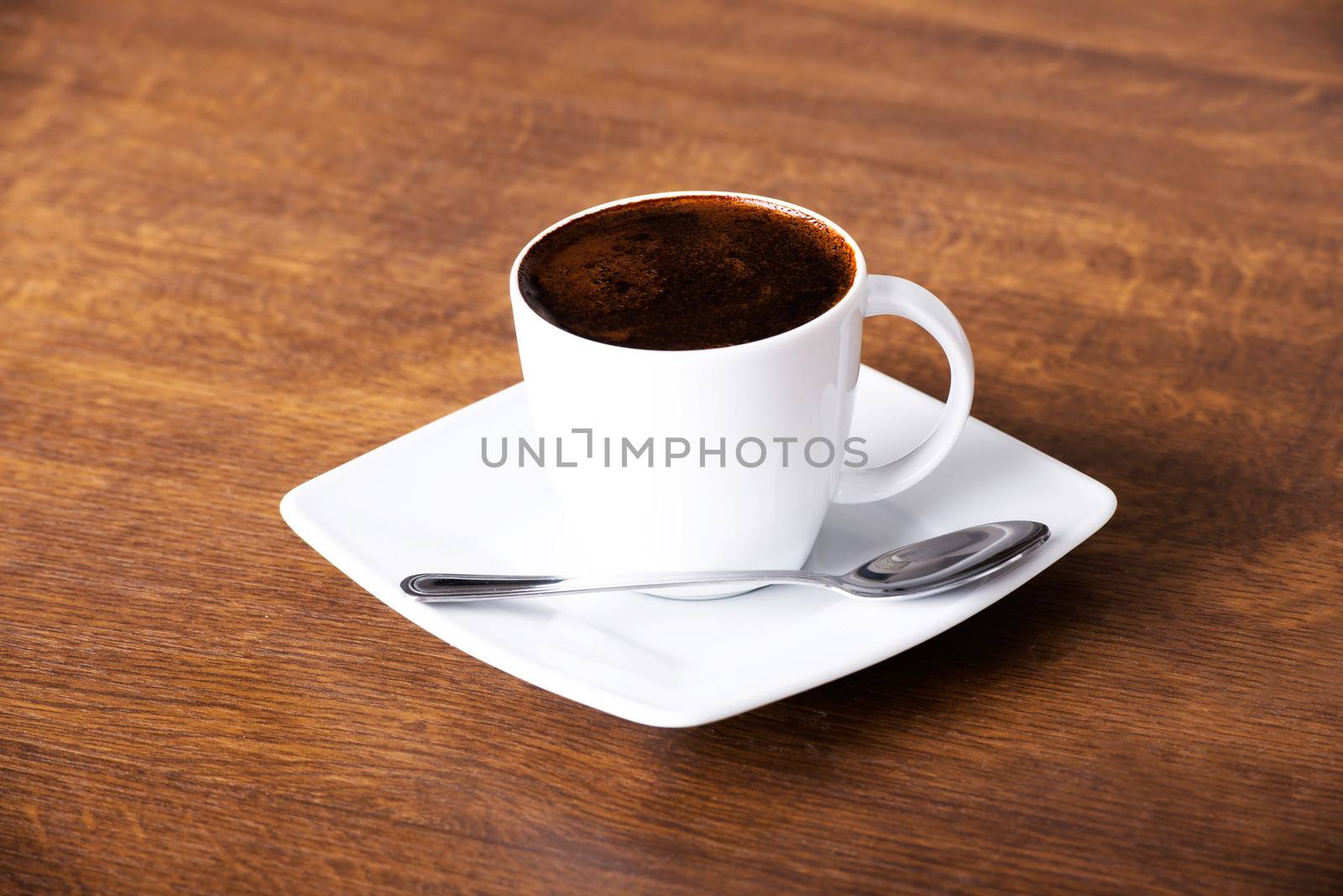 Black coffee ovwer wooden background.