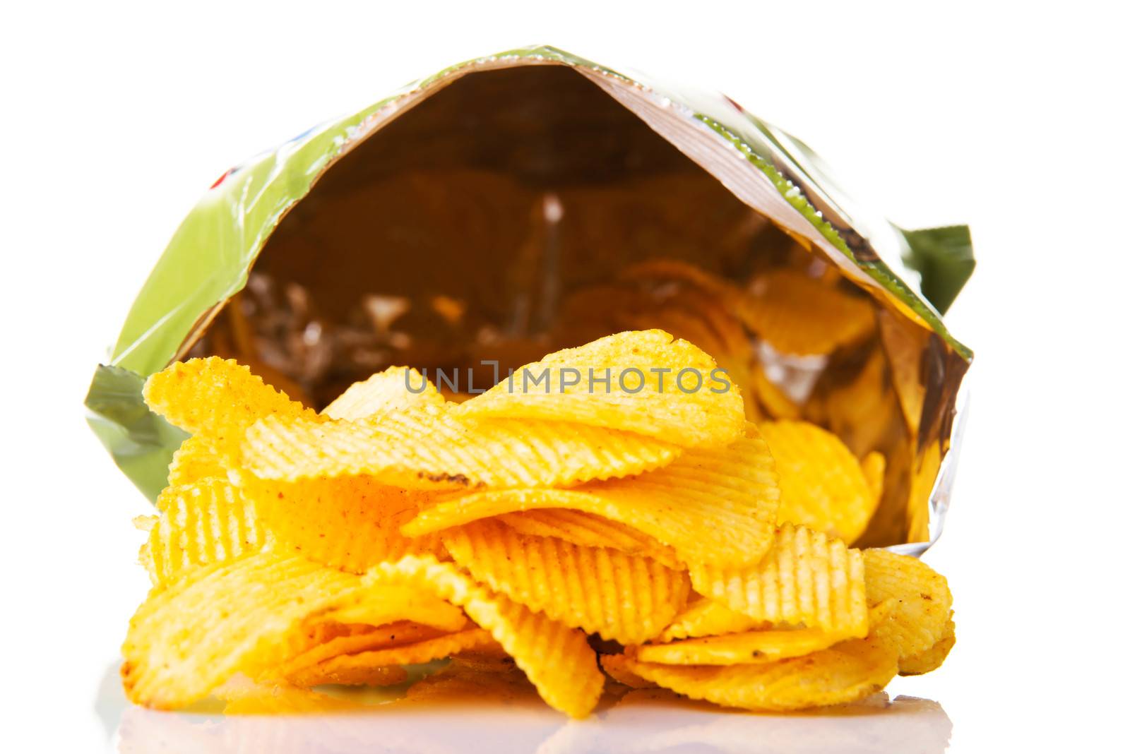Yellow, tasty but unhealthy potatoe chips. Isolated on white.