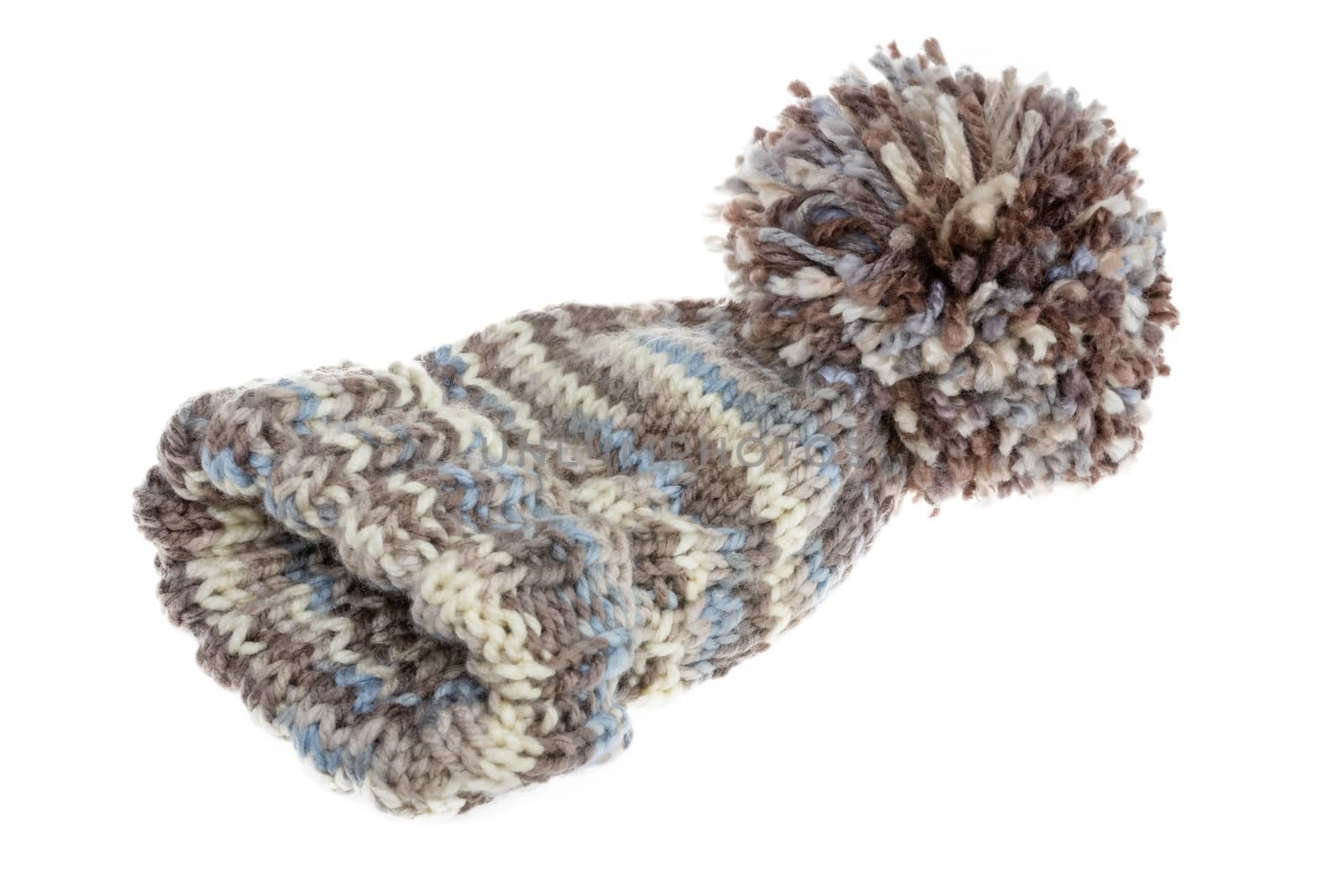 Warm woolly winter hat with a huge pompom hand-knitted from mottled grey wool on a white background