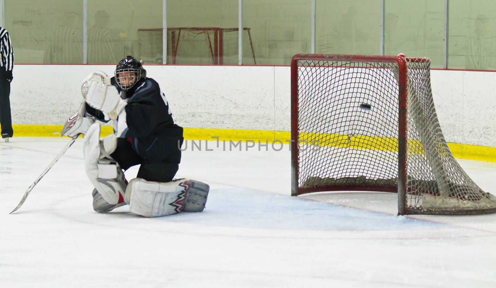 Puck gets past the goalie during an ice hockey game by bigjohn36