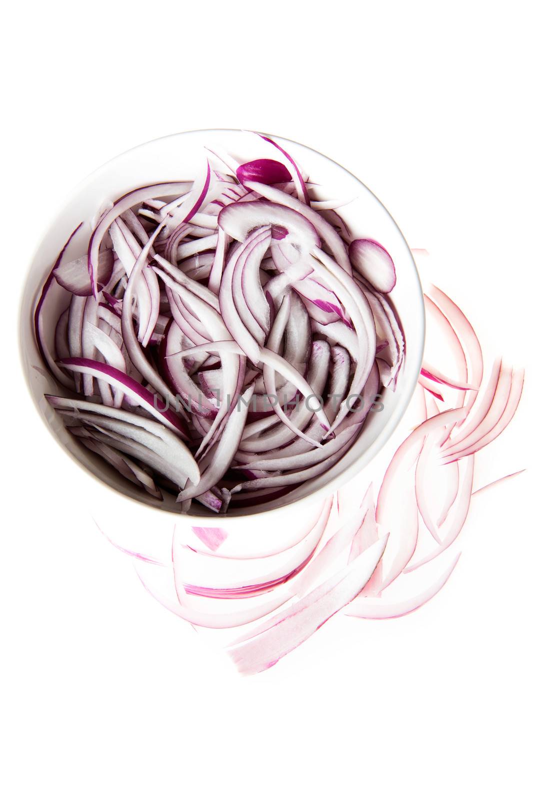 Composition of red onion rings in a bowl. by BDS