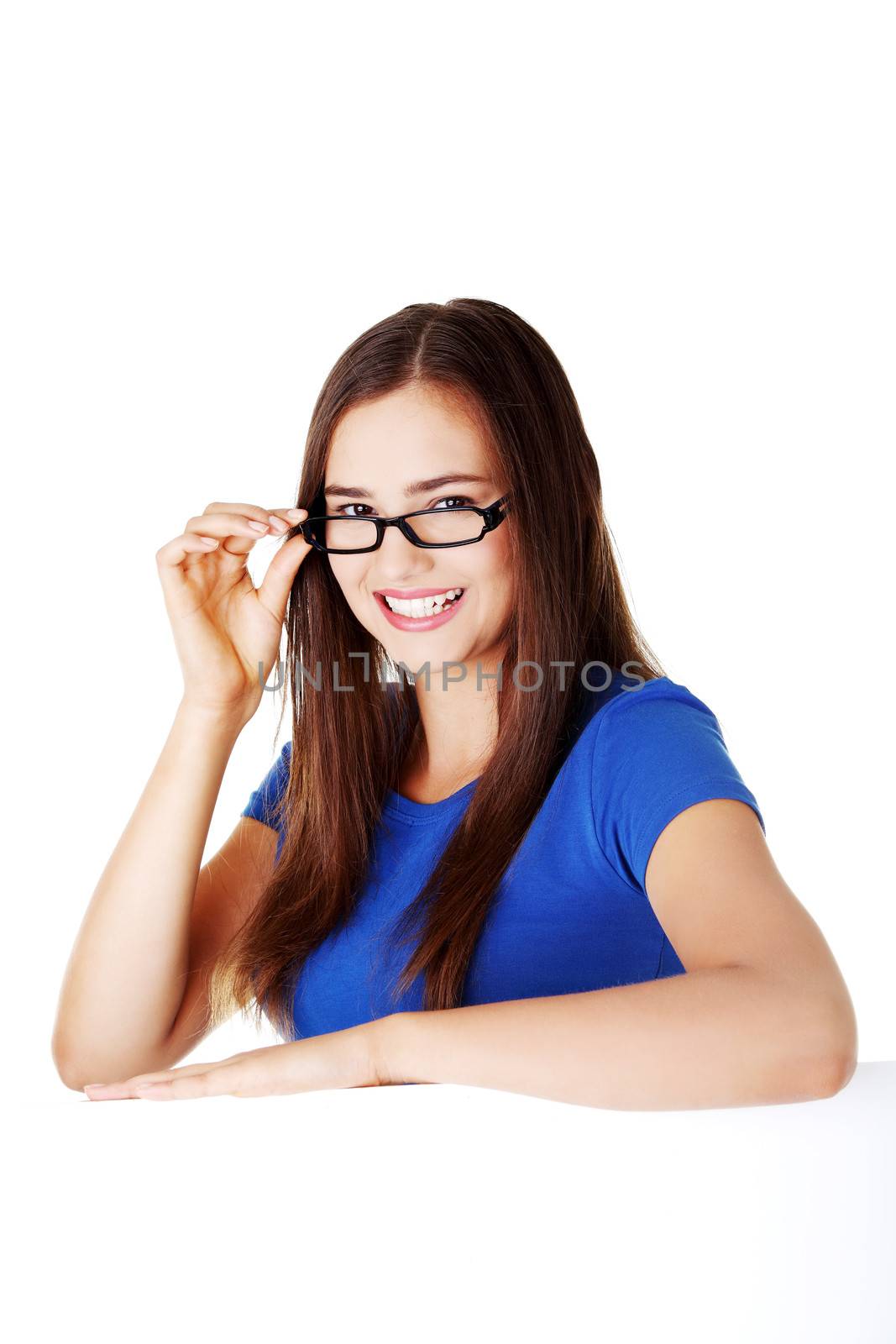 Young beautiful casual woman holding copy space. Isolated on white.