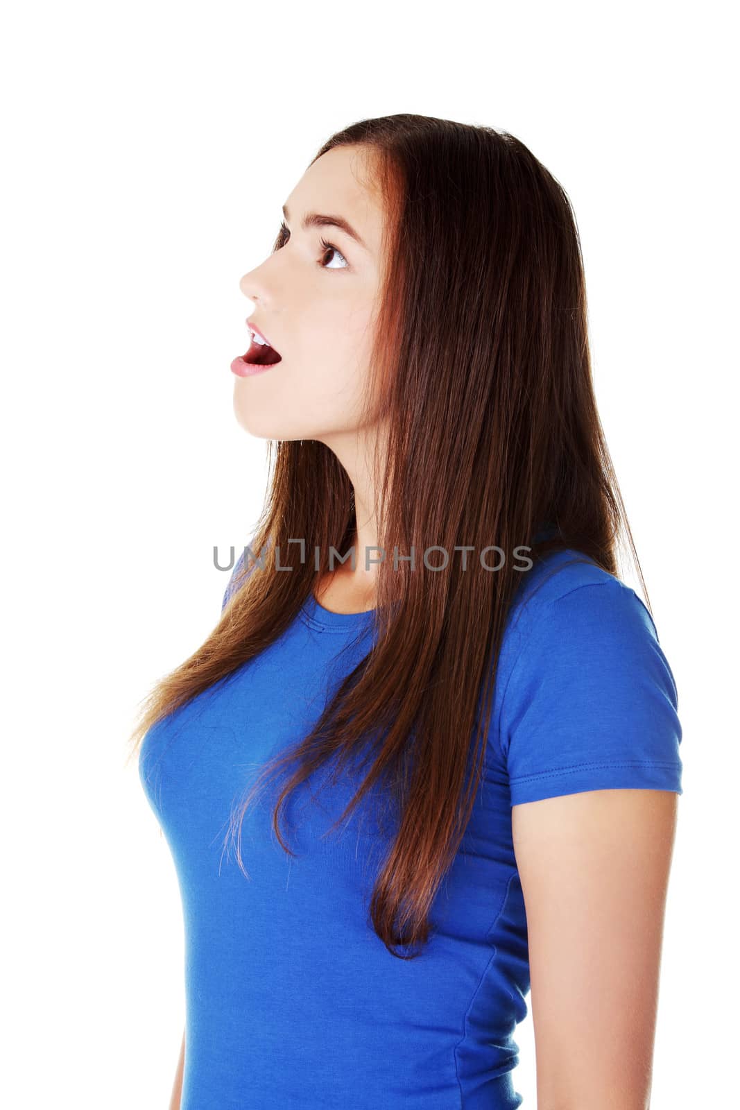 Young casual woman student expresses shock, surprise. Isolated on white.