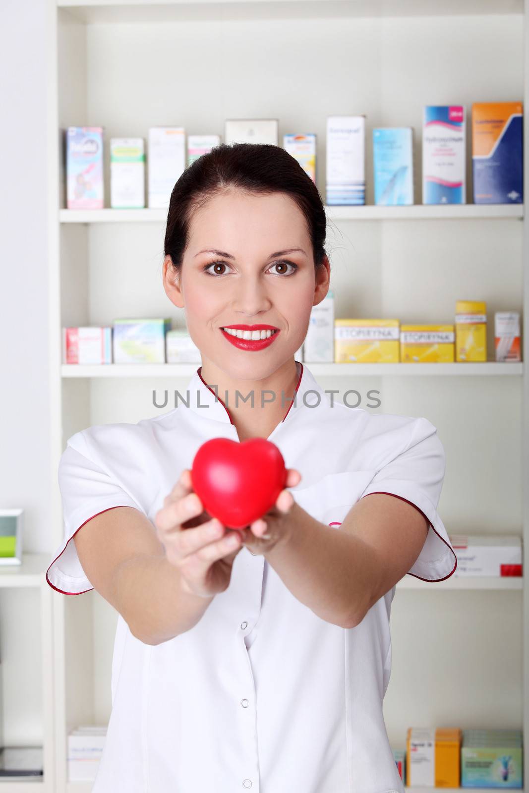 Young doctor, nurse woman holding heart. Indoor background- chemistry.