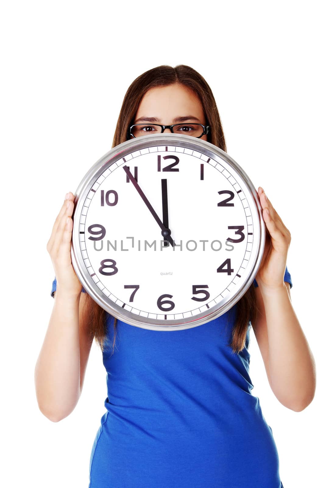 Young casual woman holding clock. Isolated on white.