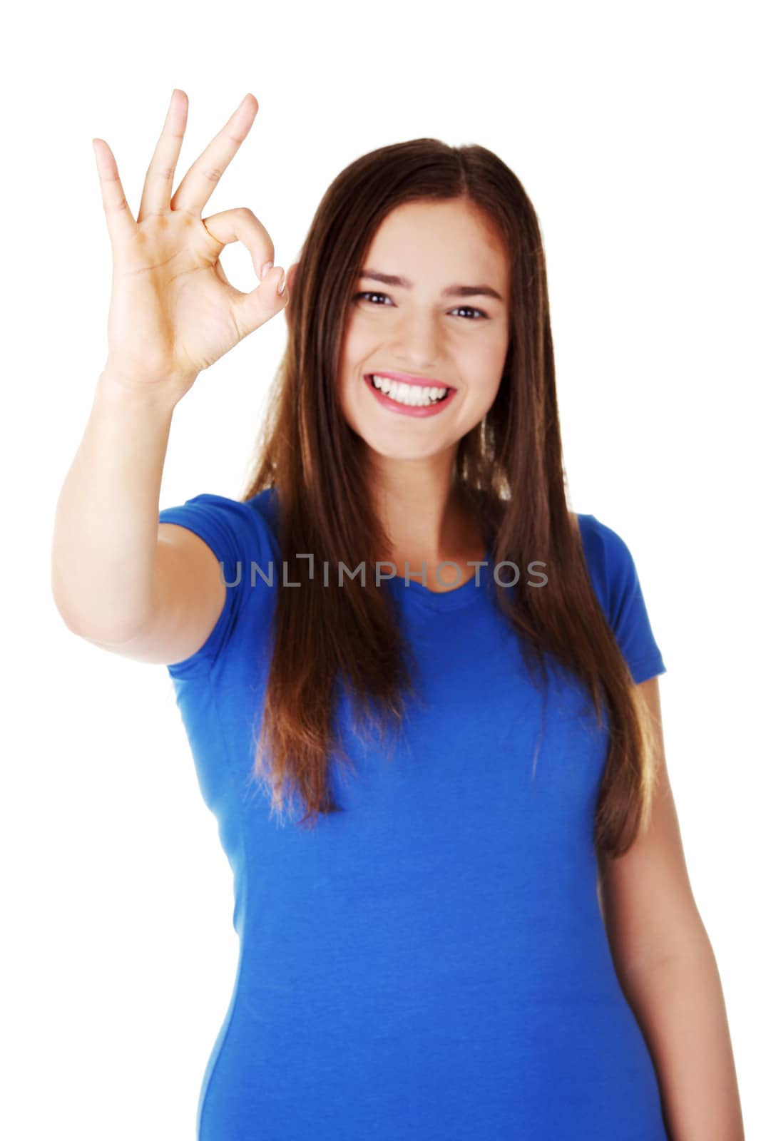 young casual woman student showin OK gesture. Isolated on white.