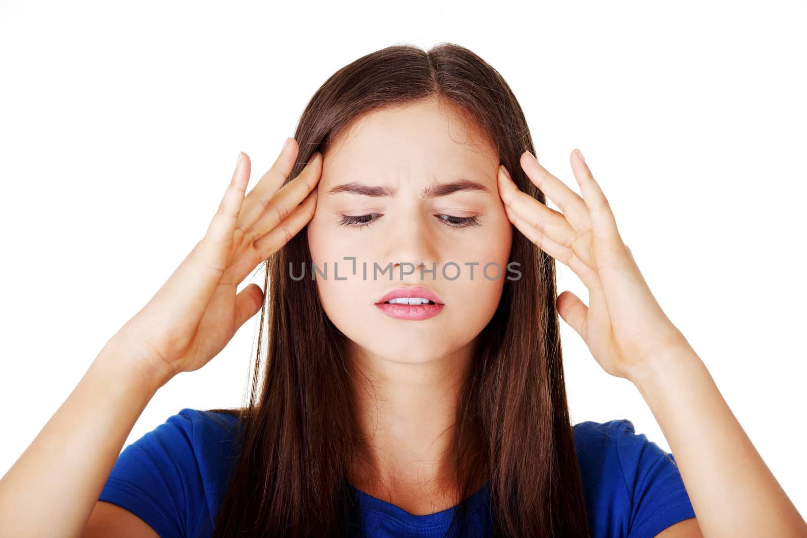 Young beautiful casual woman is touching her temples. Isolated on white.