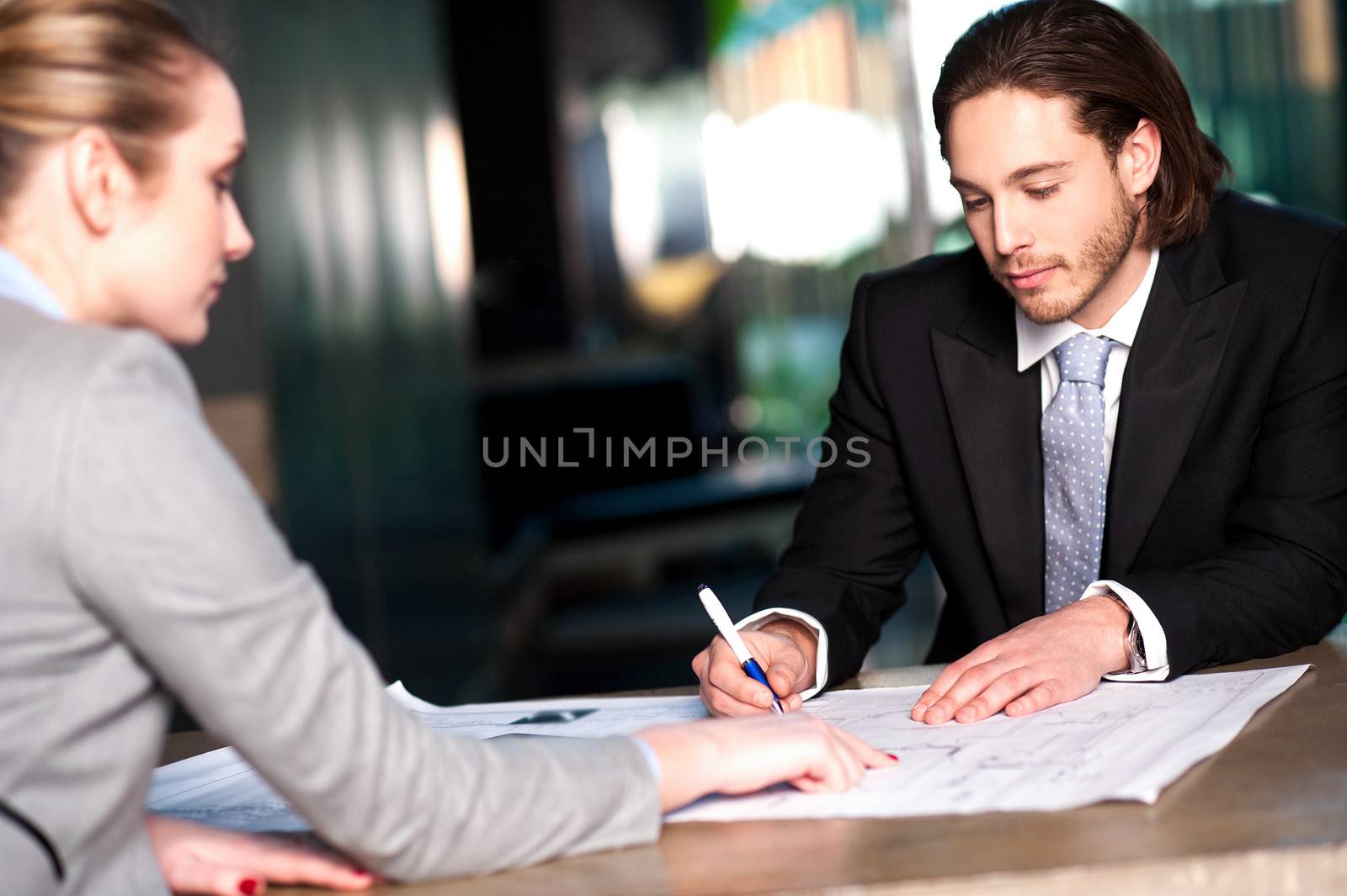 Colleagues discussing business plan by stockyimages