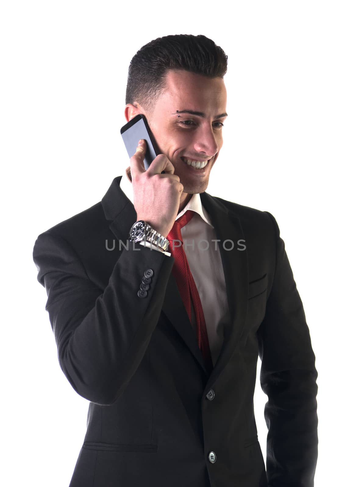 Attractive young businessman using his mobile phone, isolated on white, smiling