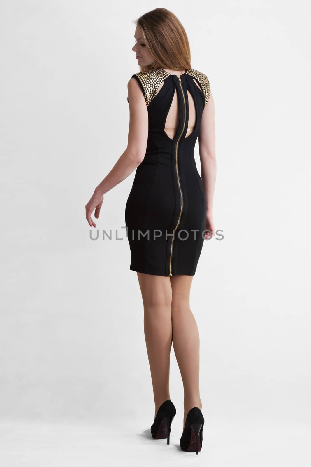 Young girl blonde in black short dress to utmost high-heeled