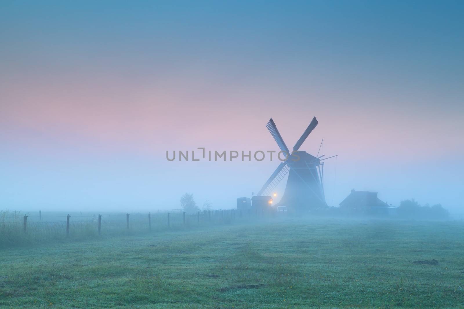 Dutch windmill in fog at sunrise, Groningen, Netherlands