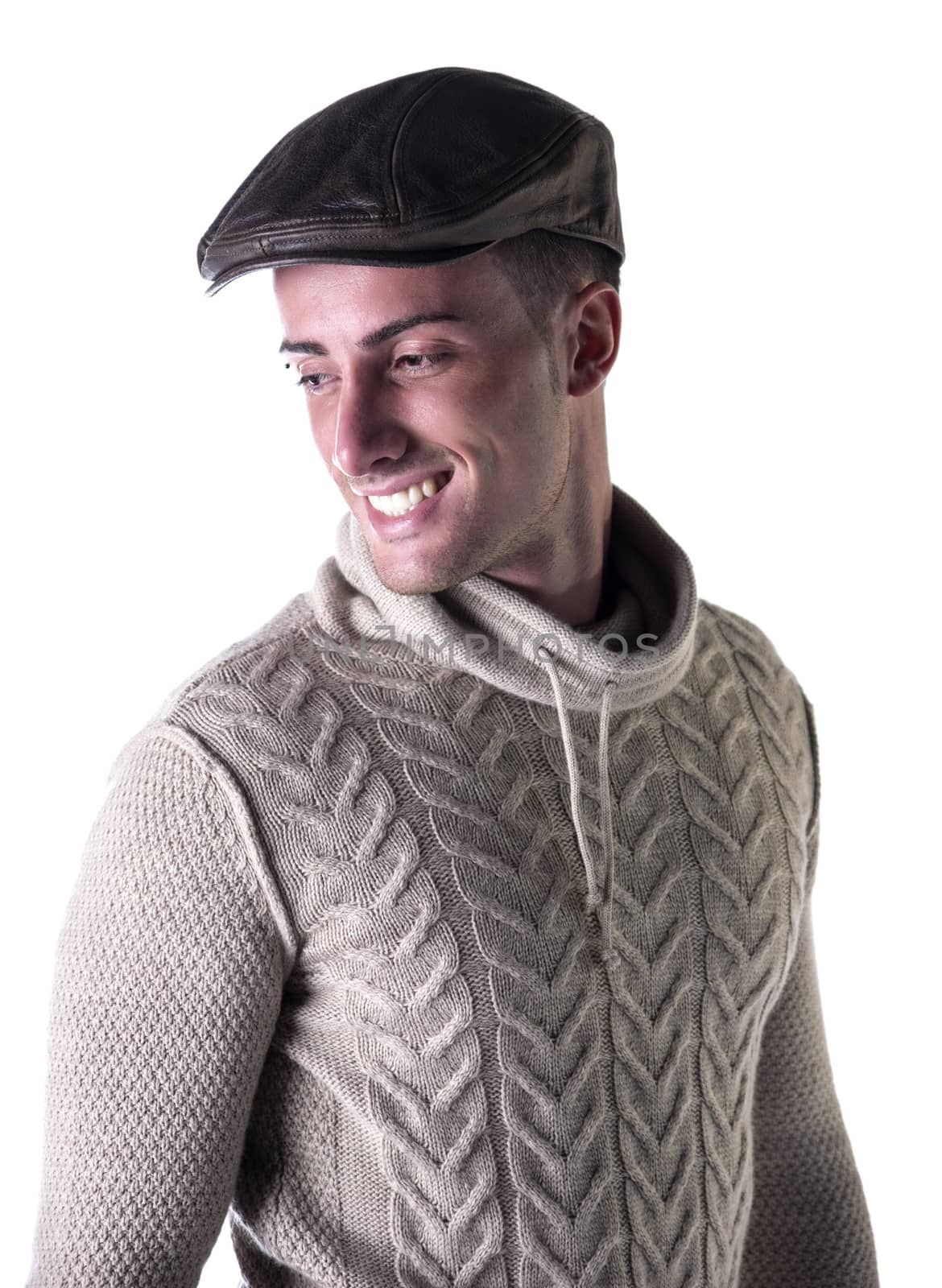 Handsome young man smiling, wearing knitted wool sweater and hat by artofphoto