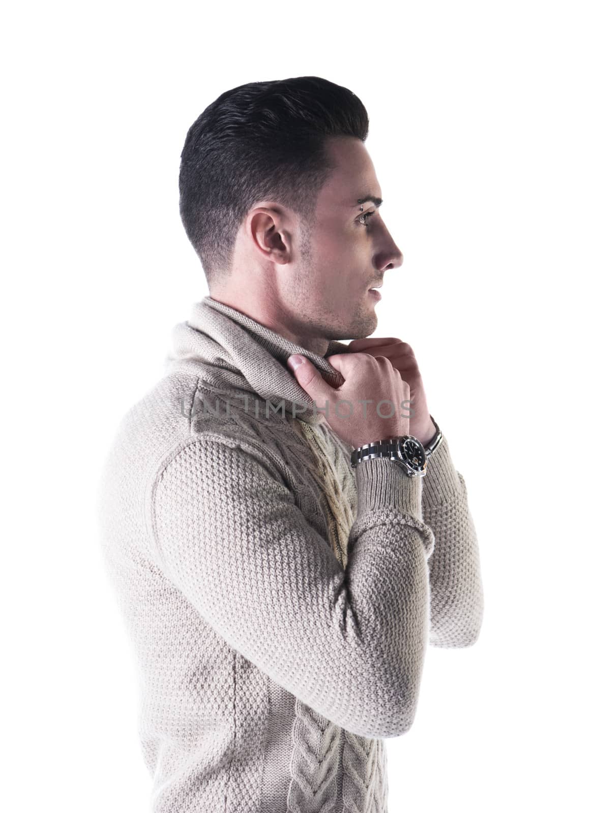Profile shot of handsome young man with wool sweater isolated on white background