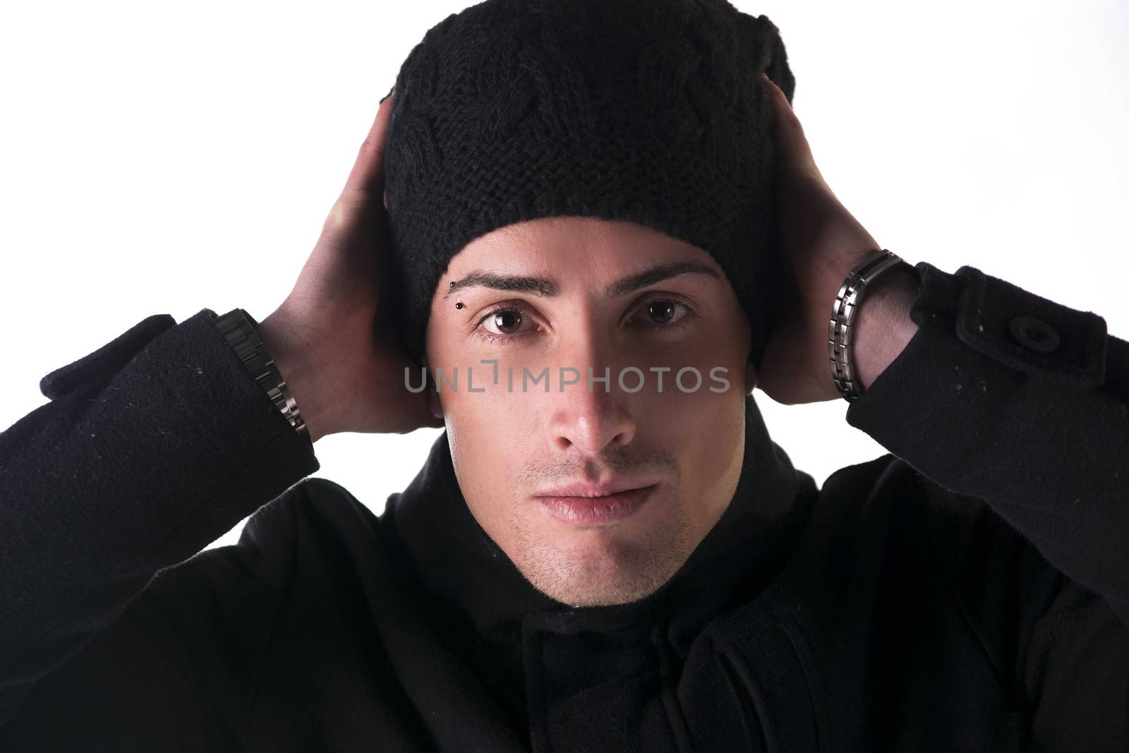 Headshot of young man with wool hat and winter coat, isolated on white