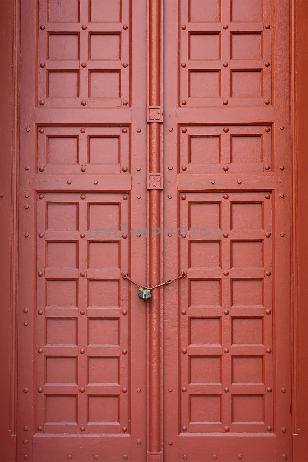 A brown vintage ornate decorative timber door in Grand Palace, Thailand