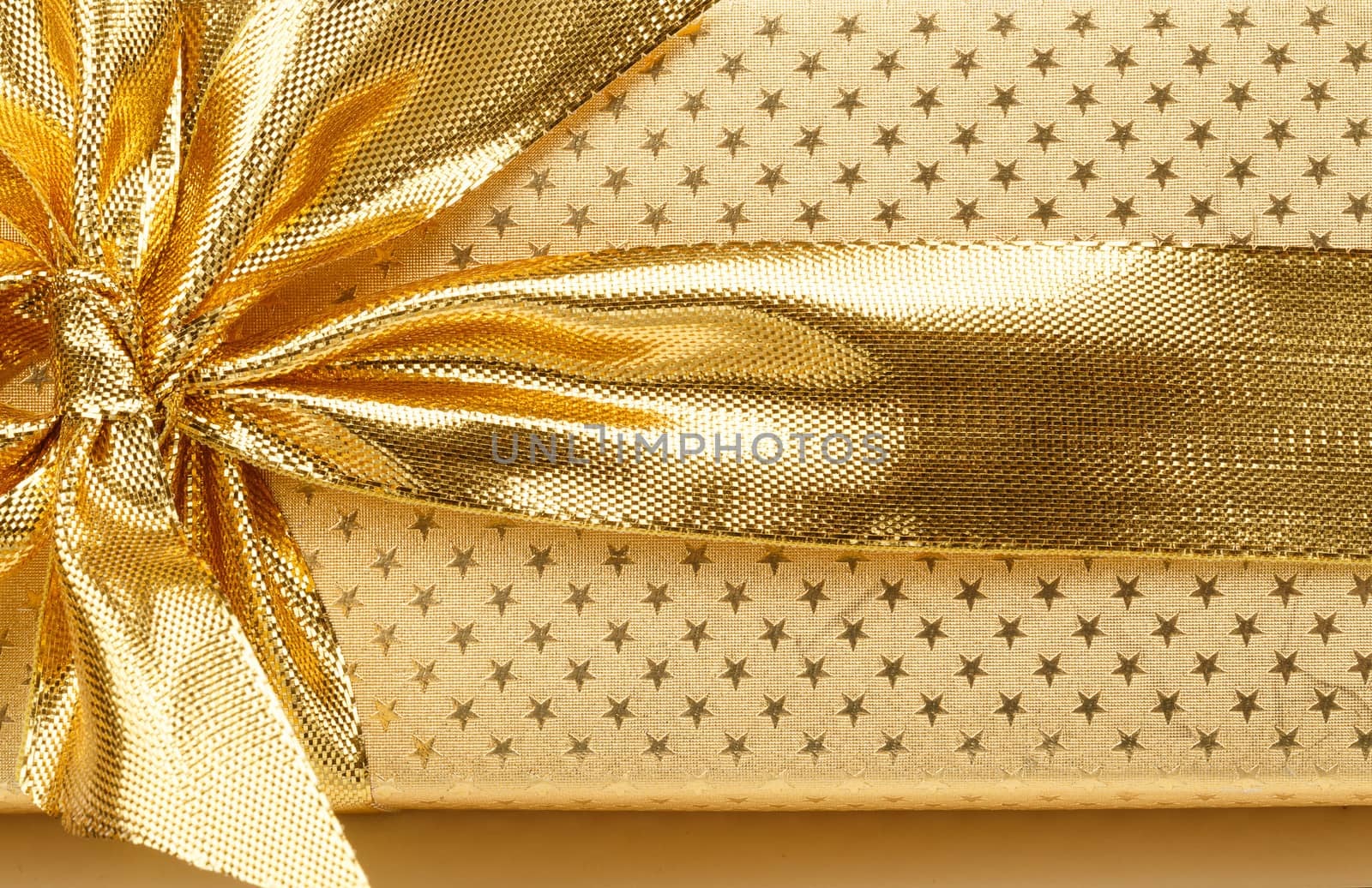 close up detail of golden ribbon on luxury gift
