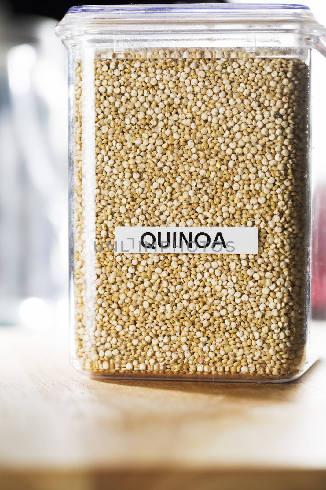 Quinoa in labeled container on counter.