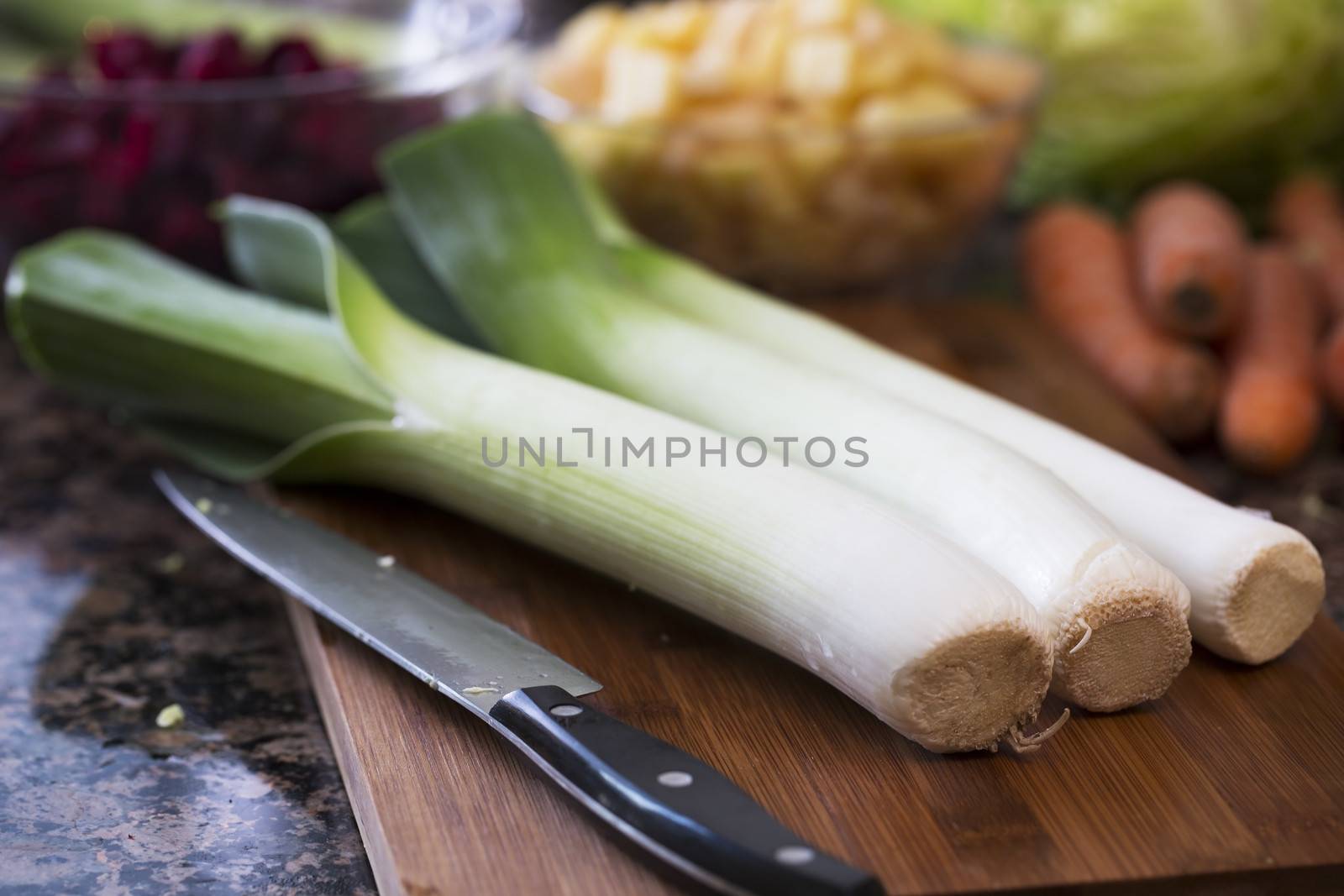 Leeks on cutting board with knife
