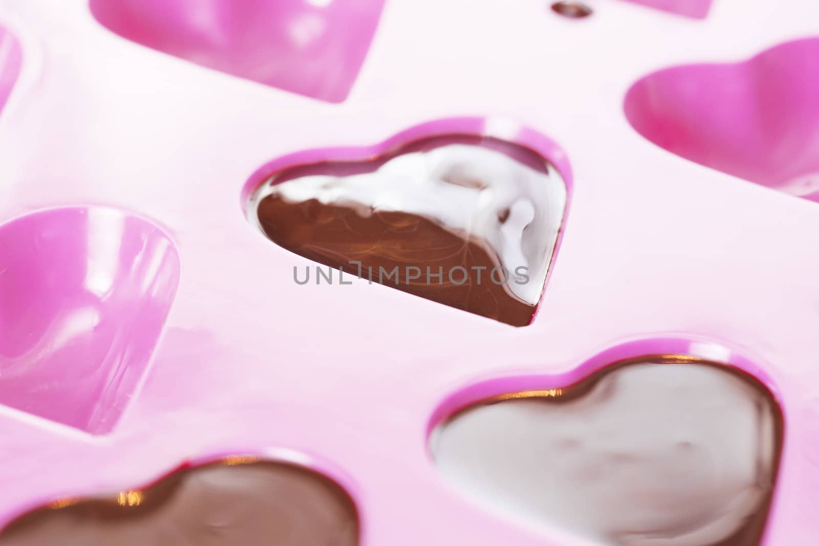 Close up of warm chocolate that has just been poured into a heart mould