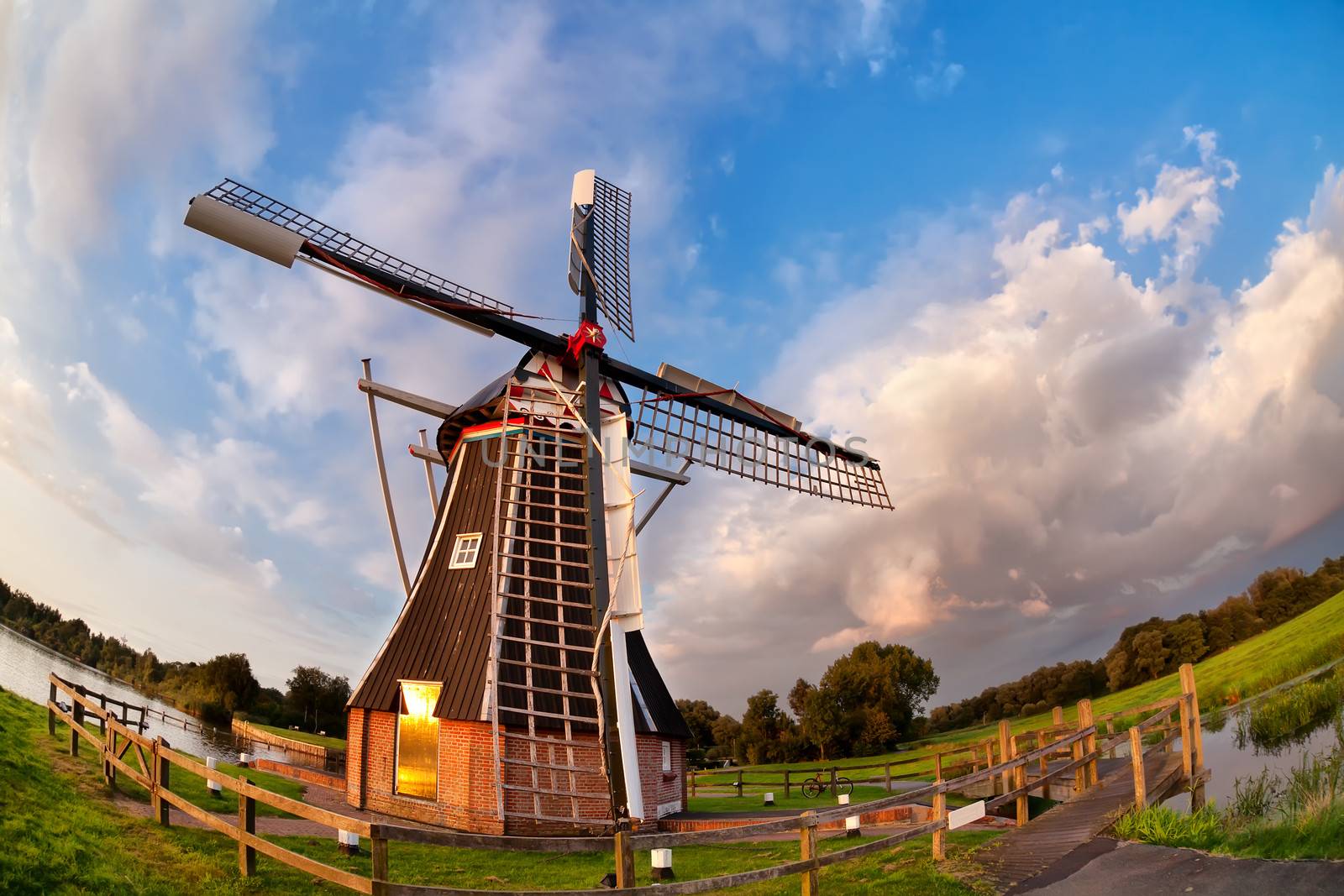 Dutch windmill over blue sky by catolla