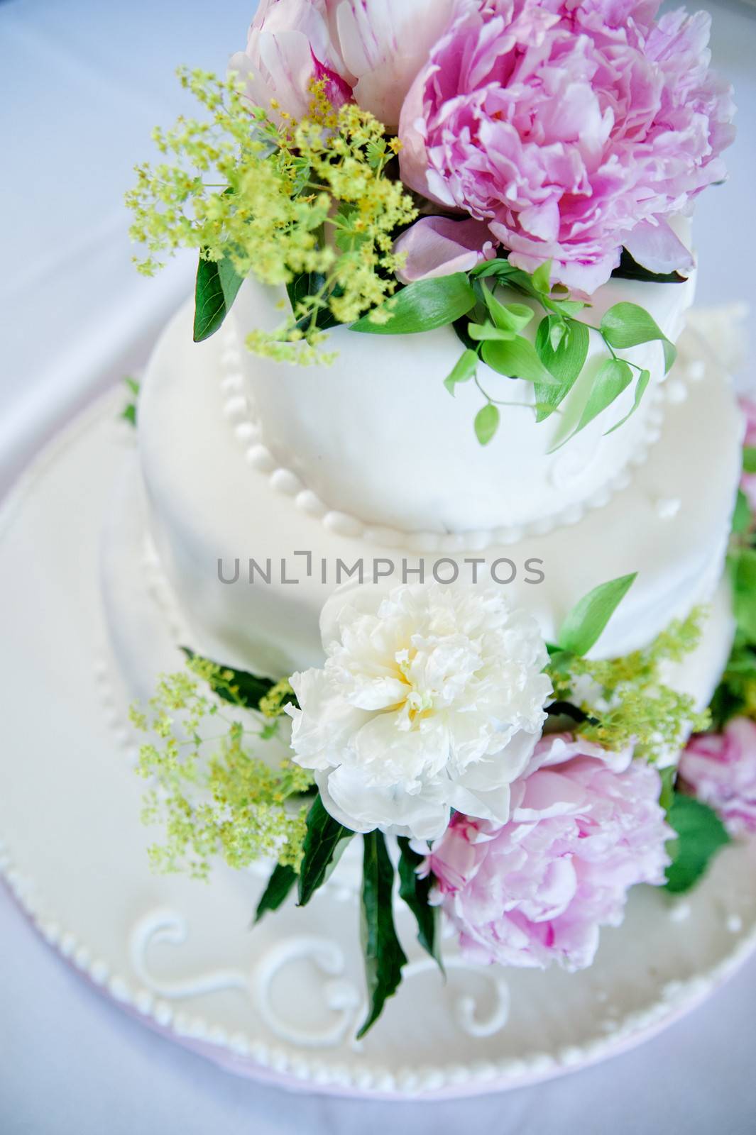 multi level white wedding cake with pink roses