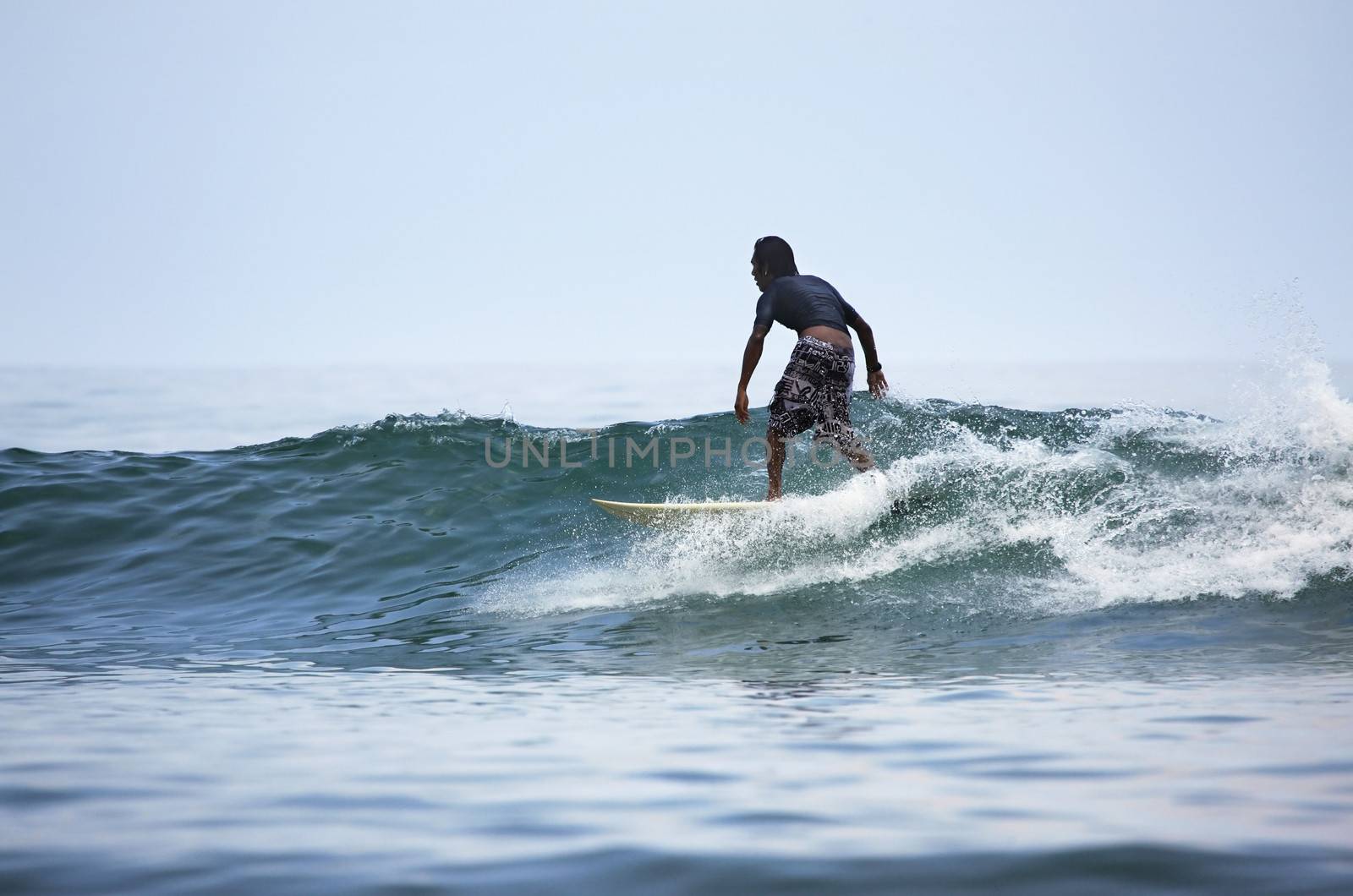 Man-surfer in ocean. Bali. Indonesia