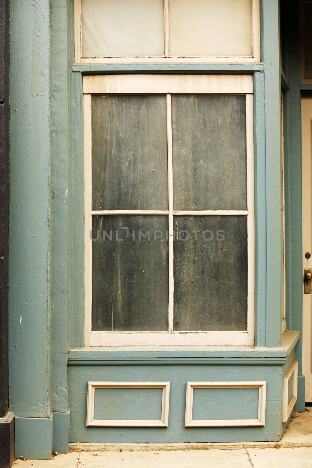 Old dirty window on old blue wall