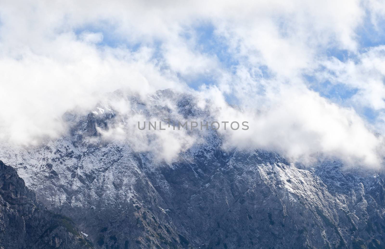 high mountain peak in white clouds by catolla